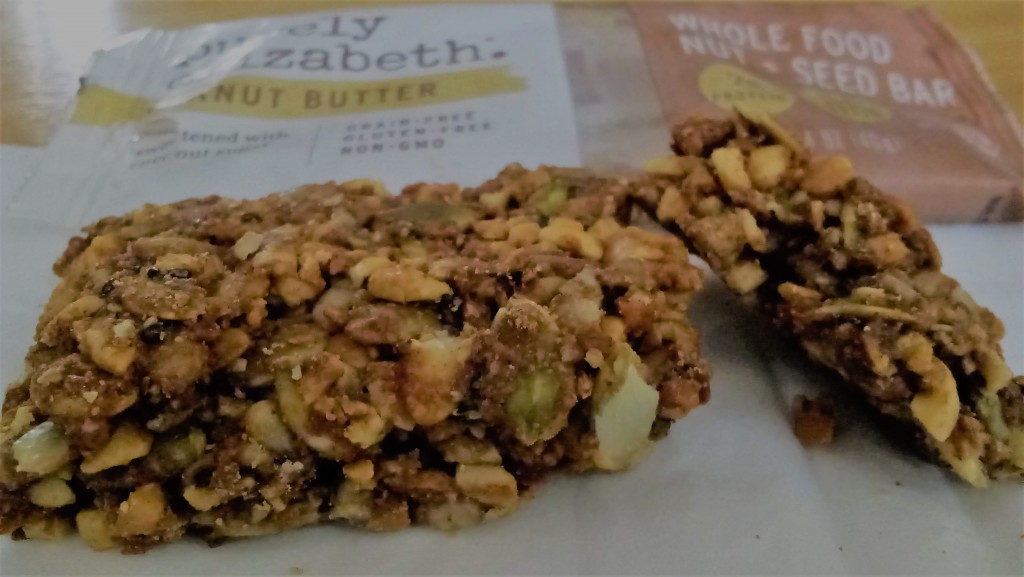Purely Elizabeth Peanut Butter bar - the image shows the bar itself, with the wrapper in the background.